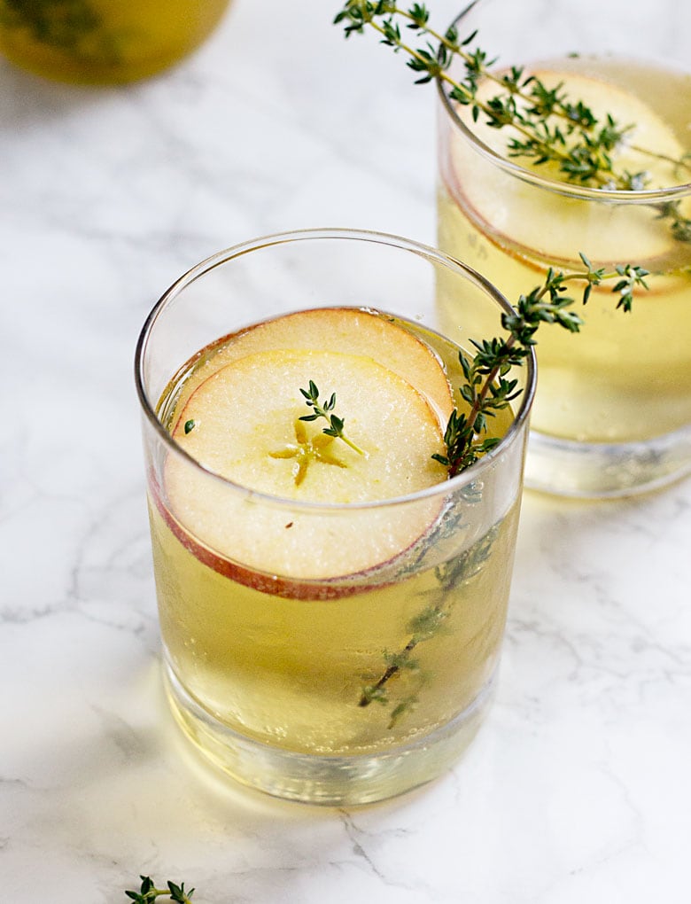 If you're having a fall or winter wedding, then you need to make this Spiked Apple Cider one of your signature cocktails. It's an upscale twist on classic apple cider, served with orange liquor, sliced apples, a sprig of rosemary and a dash of champagne for bubbles.